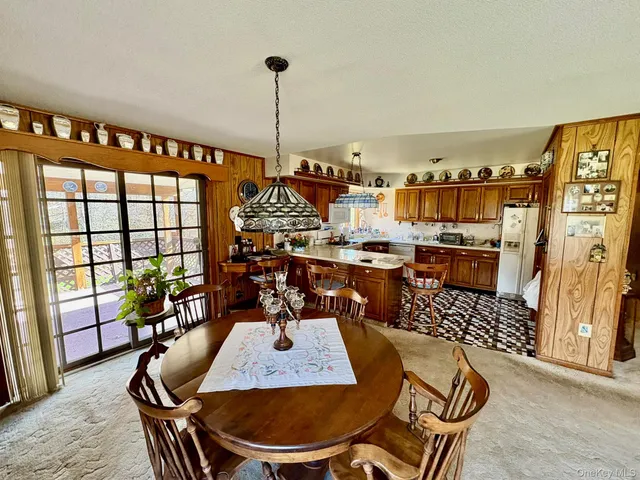 a view of a dining room with furniture window and outside view