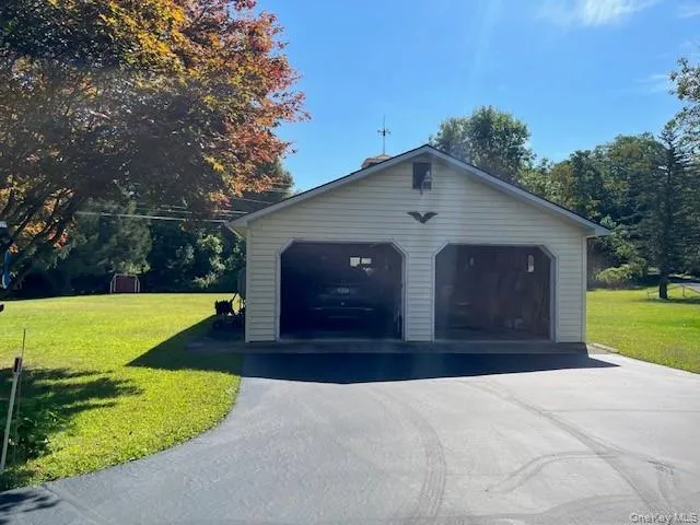 a front view of a house with yard and green space