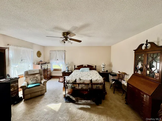 a bed room with furniture and a flat screen tv