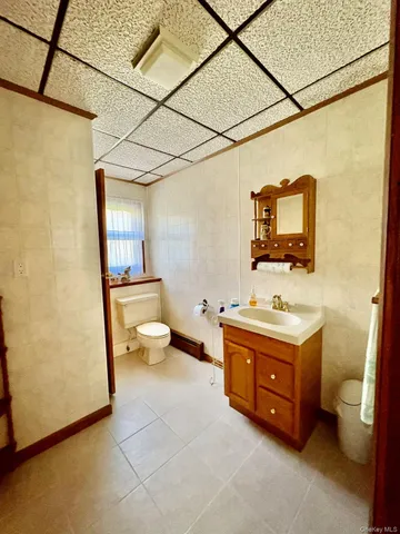 a spacious bathroom with a toilet sink and mirror