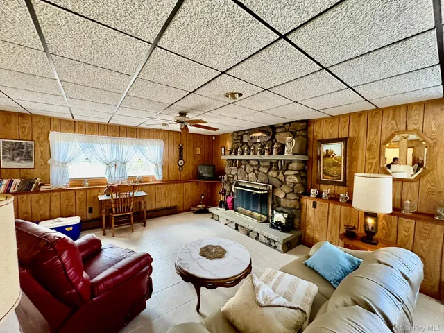 a living room with furniture a fireplace and a flat screen tv