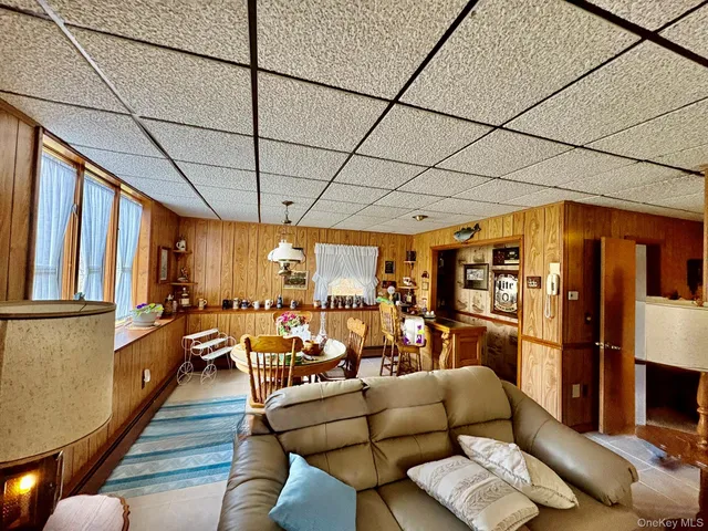 a living room with furniture and a floor to ceiling window