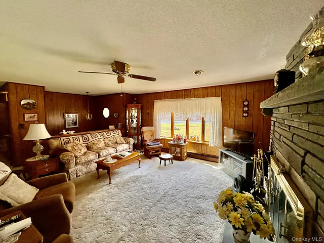 a living room with furniture fireplace and a window