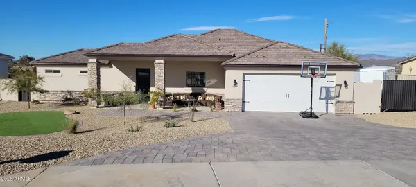 a view of a house with backyard and sitting area