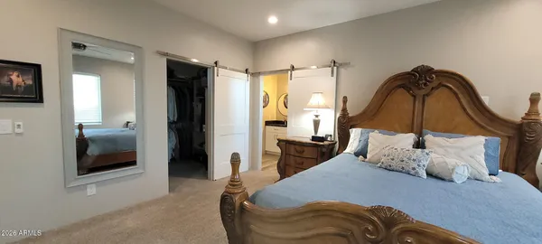 a bedroom with a bed and glass door