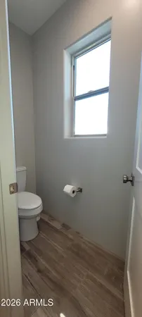 a bathroom with a toilet and a window