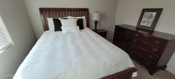 a bed room with a bed and a television