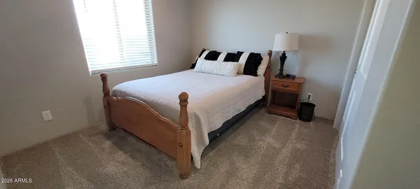 a bed sitting in a bedroom next to a window