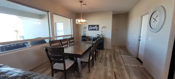 a view of a dining room with furniture and wooden floor
