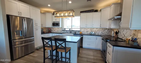 a kitchen with a refrigerator and a sink