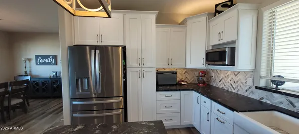 a kitchen with stainless steel appliances a refrigerator stove and sink