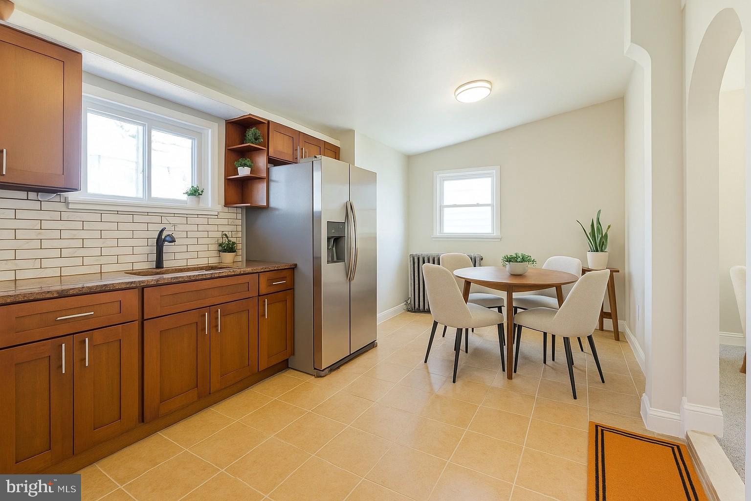 349 South Springfield Road Clifton Heights, PA 19018 - Photo 2 of 40 a kitchen with a table chairs refrigerator and cabinets