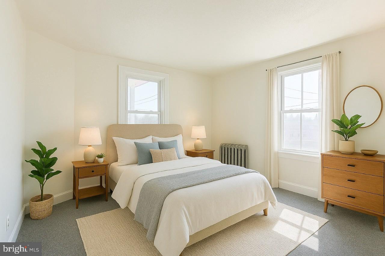 349 South Springfield Road Clifton Heights, PA 19018 - Photo 23 of 40 a bedroom with a bed and a potted plant