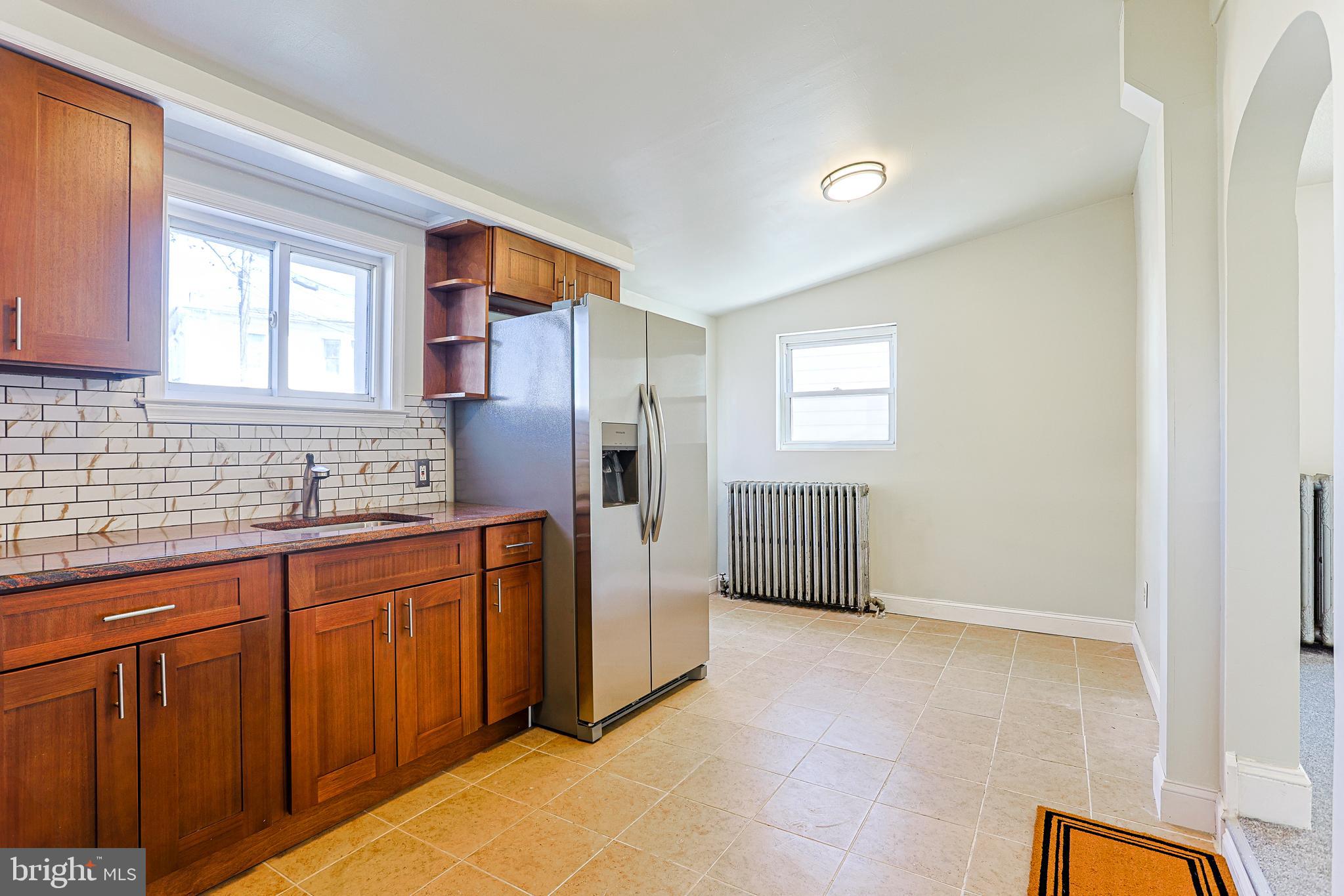 349 South Springfield Road Clifton Heights, PA 19018 - Photo 3 of 40 a kitchen with stainless steel appliances granite countertop a refrigerator and sink