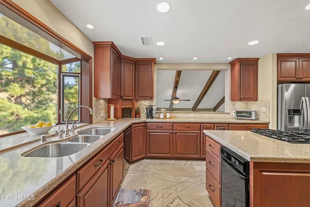 a living room with furniture a fireplace and a floor to ceiling window