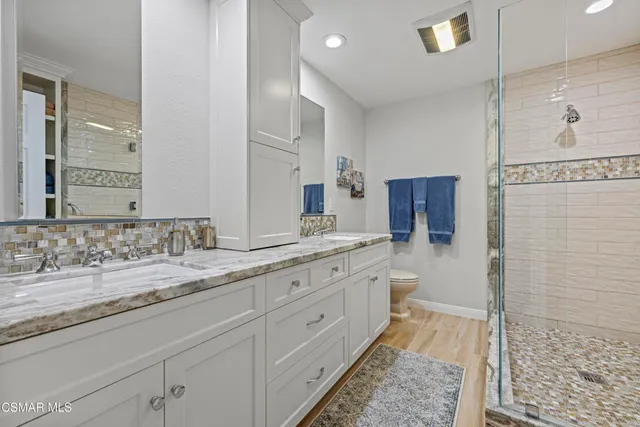 a bedroom with a large bed and dresser