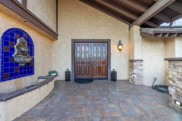 a bathroom with a granite countertop toilet a sink and mirror