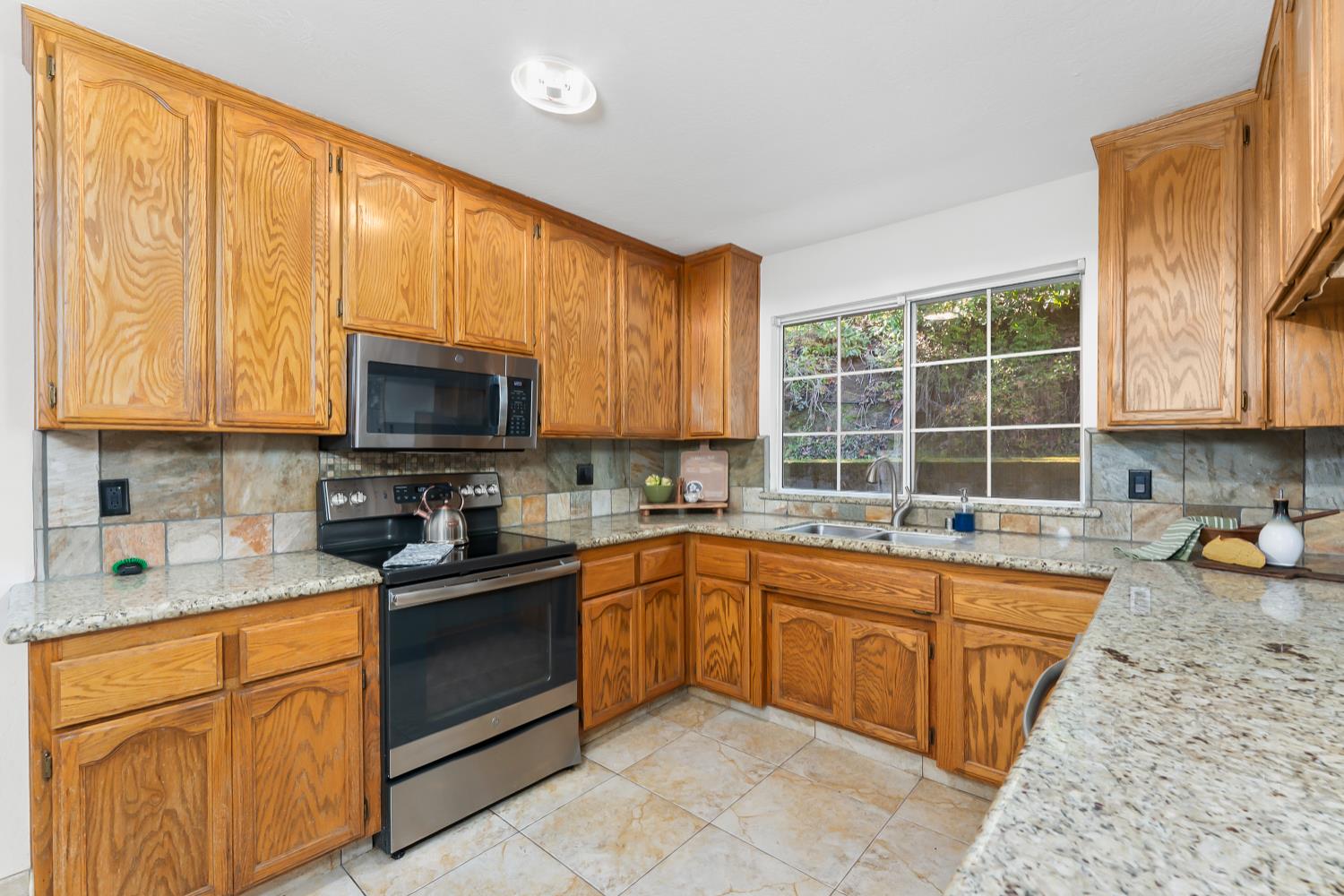 2960 Pasada Road Cameron Park, CA 95682 - Photo 11 of 40 a kitchen with a sink stove top oven and microwave