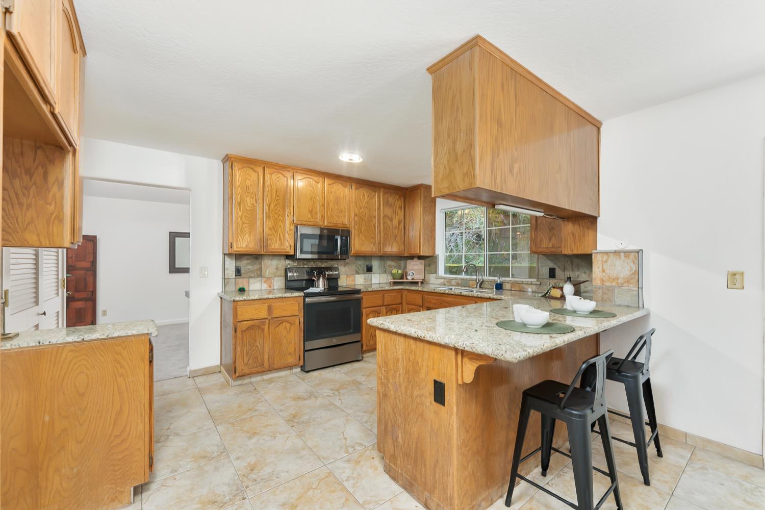 2960 Pasada Road Cameron Park, CA 95682 - Photo 13 of 40 a kitchen with a sink stove and cabinets