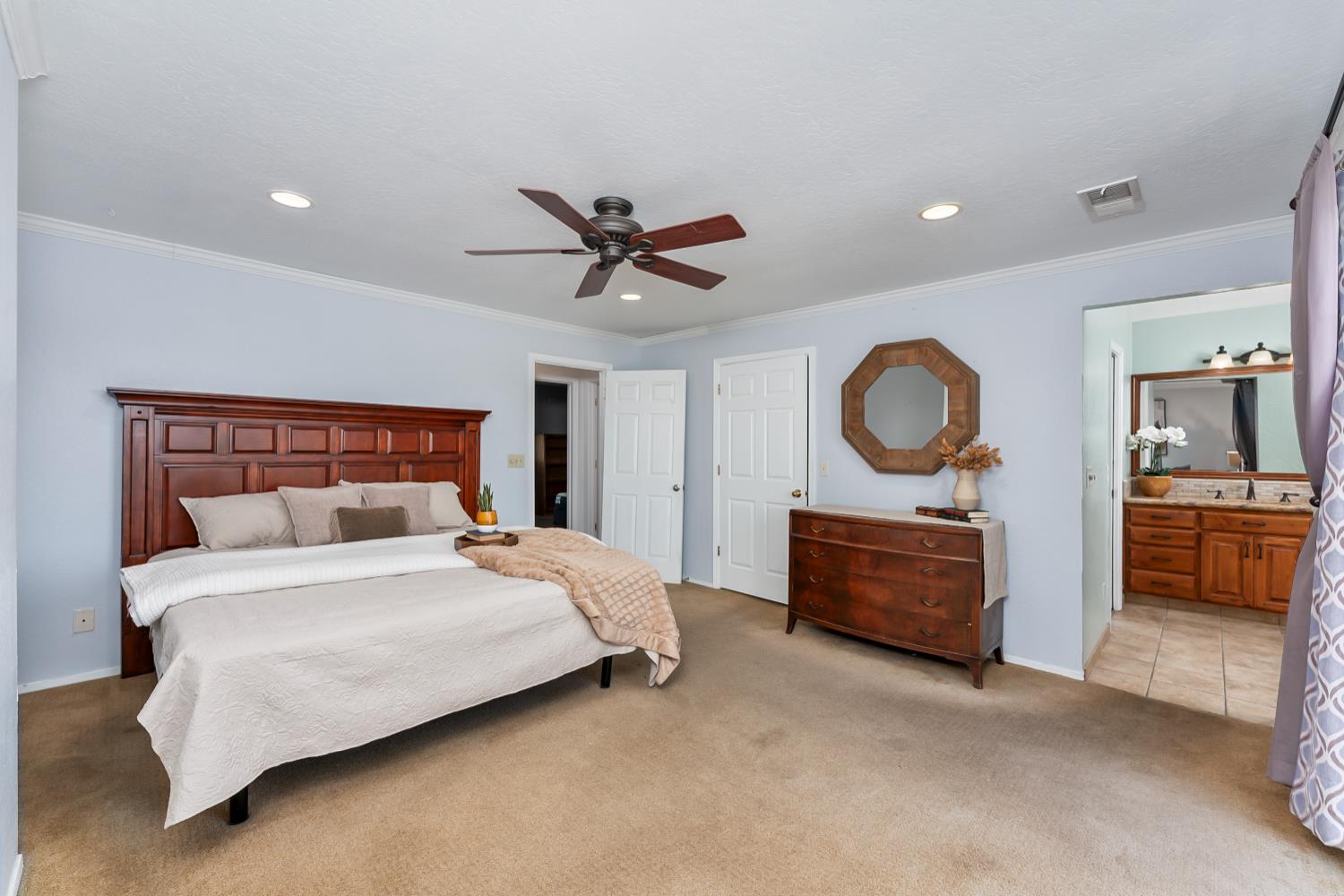 2960 Pasada Road Cameron Park, CA 95682 - Photo 22 of 40 a bedroom with a large bed and a chandelier