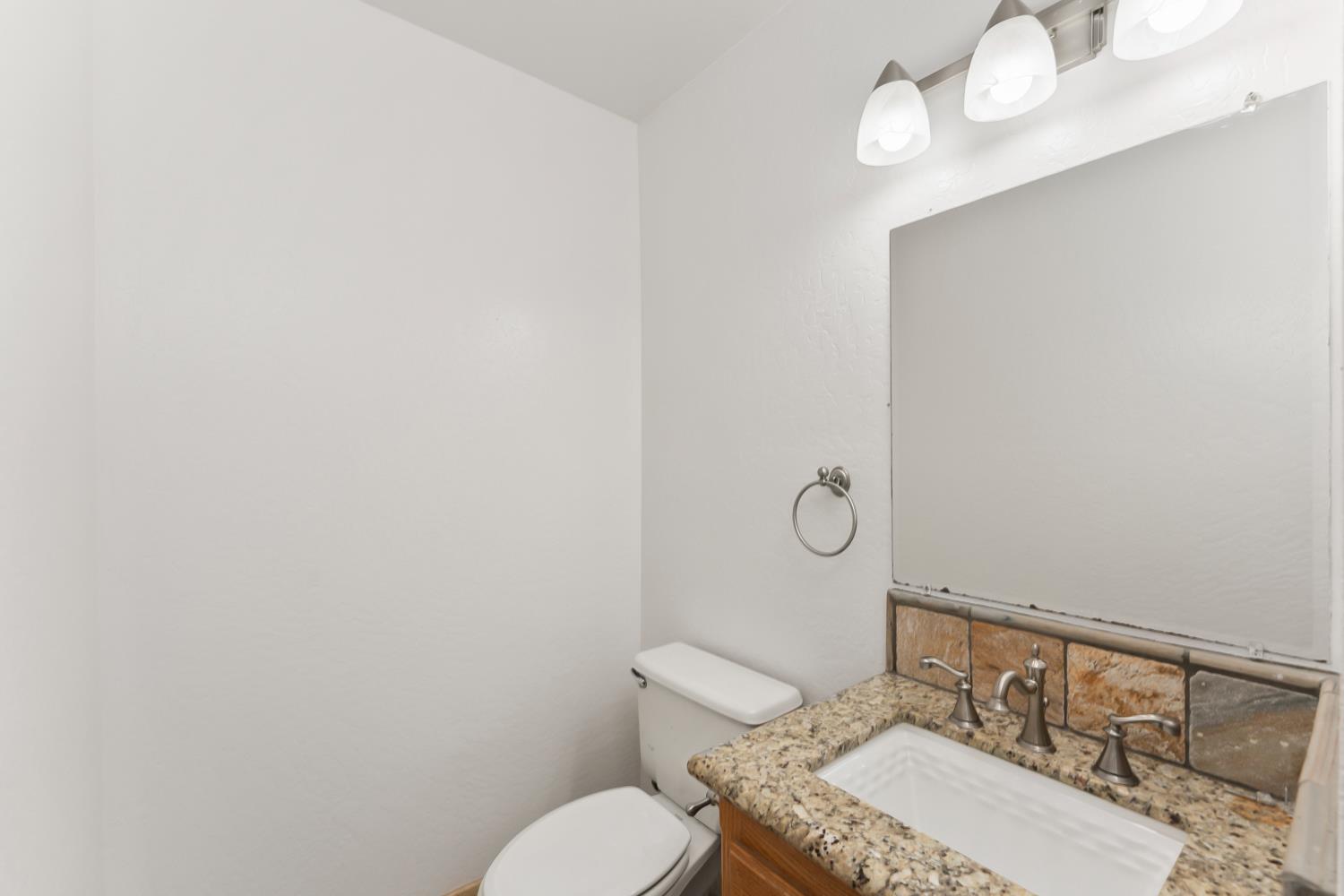 2960 Pasada Road Cameron Park, CA 95682 - Photo 31 of 40 a bathroom with a granite countertop toilet and a sink