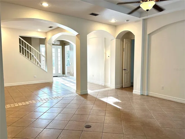 a view of a hallway with entryway and chandelier
