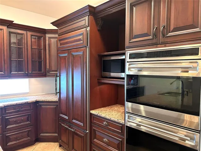 a kitchen with granite countertop stainless steel appliances and granite counter tops
