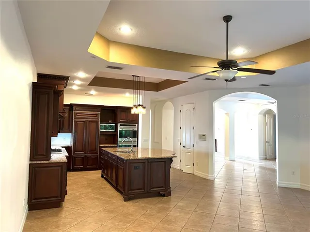 a kitchen with stainless steel appliances granite countertop a sink and a refrigerator