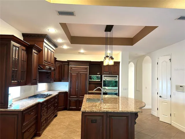 a kitchen with a cabinets and chandelier