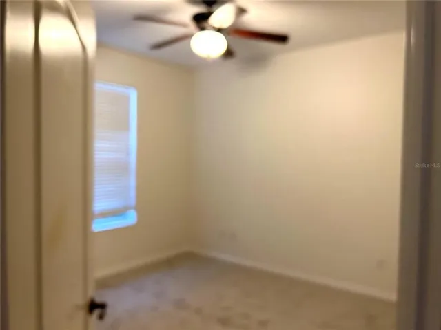 a kitchen view of a refrigerator and cabinets