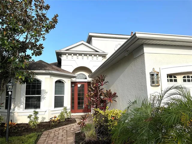 a front view of a house with plants