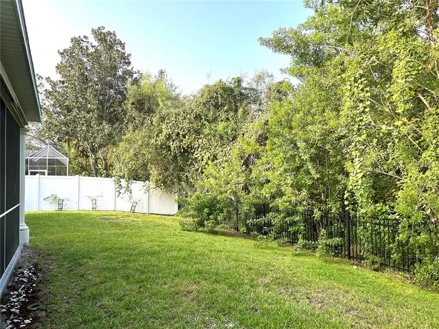 a view of a house with backyard porch and sitting area
