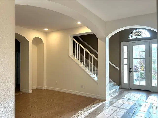 a view of a hallway with entryway and front door