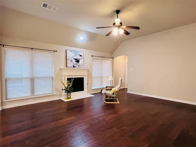 a living room with fireplace furniture and a large window