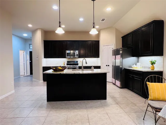 a kitchen with a refrigerator and a sink