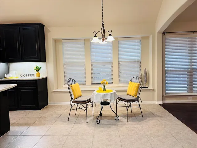 a dining room with furniture and a window
