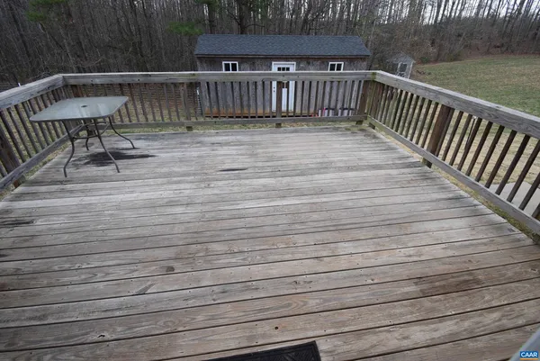 a view of deck with two chairs and wooden floor