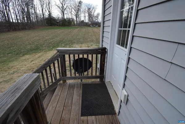 a view of balcony with wooden floor and fence