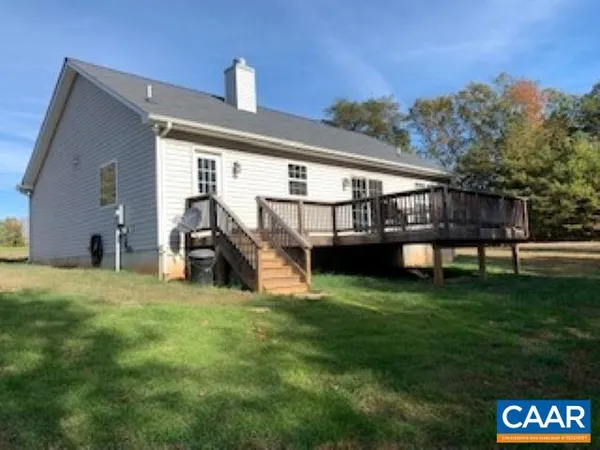 a view of a house with backyard and porch