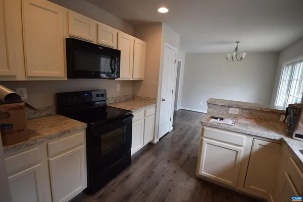 a kitchen with a stove microwave and sink