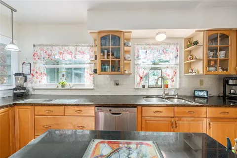 a kitchen with stainless steel appliances granite countertop a sink and cabinets