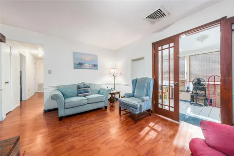 a living room with furniture and a floor to ceiling window