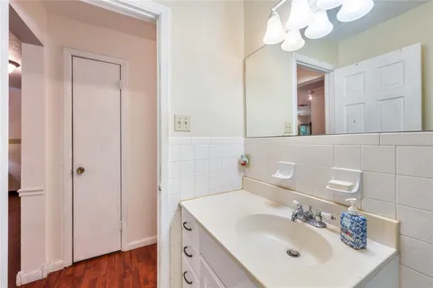 a bathroom with a sink vanity and a mirror