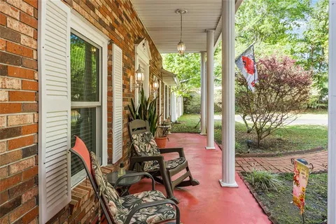 a view of a patio with table and chairs and potted plants