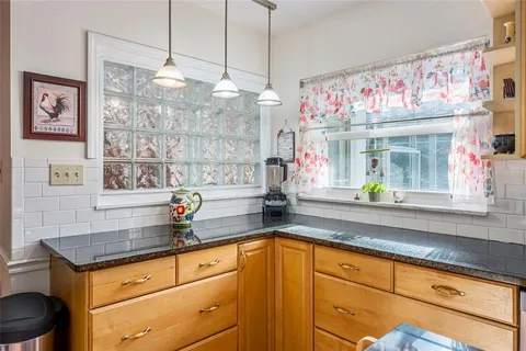 a kitchen with granite countertop a sink and a window