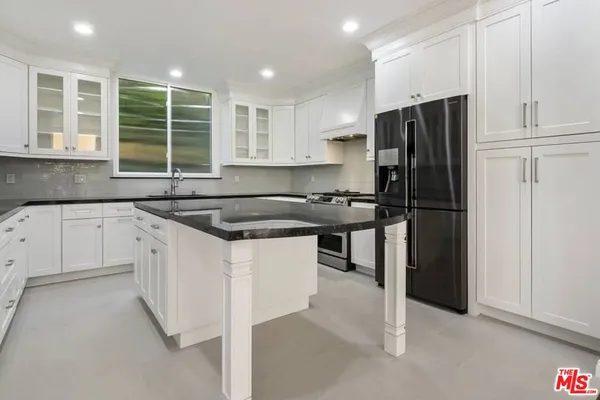 a kitchen with a refrigerator and a sink
