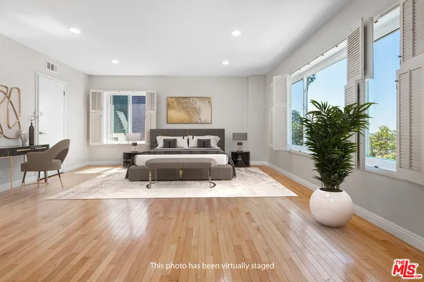 a bedroom with furniture and a potted plant