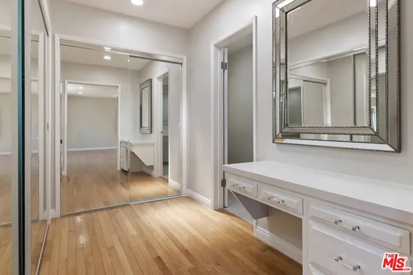 a view of a hallway and wooden floor