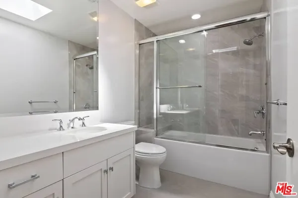 a bathroom with a sink toilet tub and shower