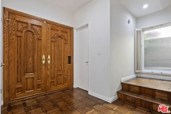 a view of a elevator with wooden floor